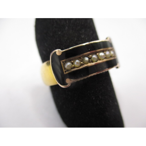 44 - An antique yellow gold mourning ring, having black enamel band with seed pearls to centre, approx. r... 