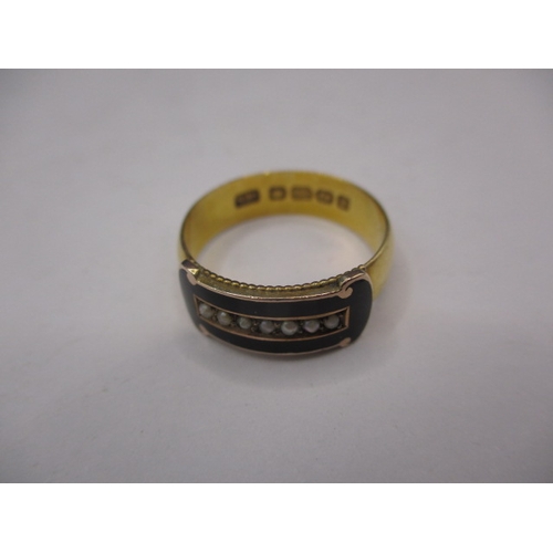 44 - An antique yellow gold mourning ring, having black enamel band with seed pearls to centre, approx. r... 