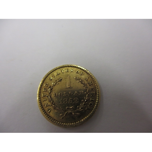 176 - A United States of America gold one dollar coin dated 1852, a circulated coin with fine definition o... 