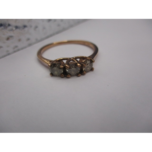 9 - A 9ct yellow gold ring with three champagne diamonds, approx. ring size ‘W’, approx. weight 2.3g in ... 