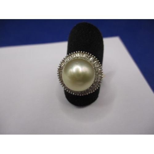 10 - A 9ct yellow gold dress ring with central pearl surrounded by diamonds, approx. ring size ‘R+’, appr... 