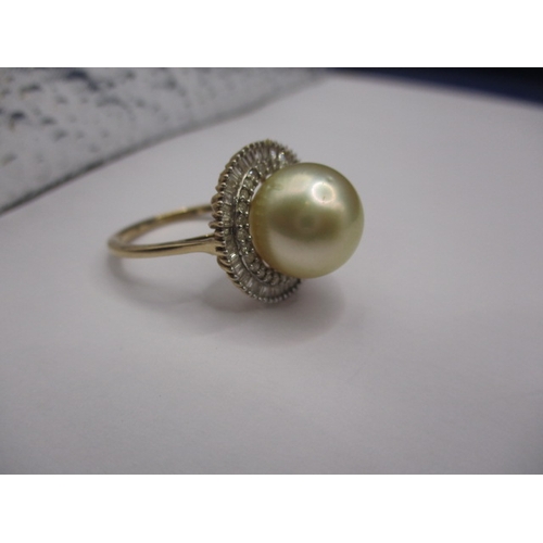 10 - A 9ct yellow gold dress ring with central pearl surrounded by diamonds, approx. ring size ‘R+’, appr... 