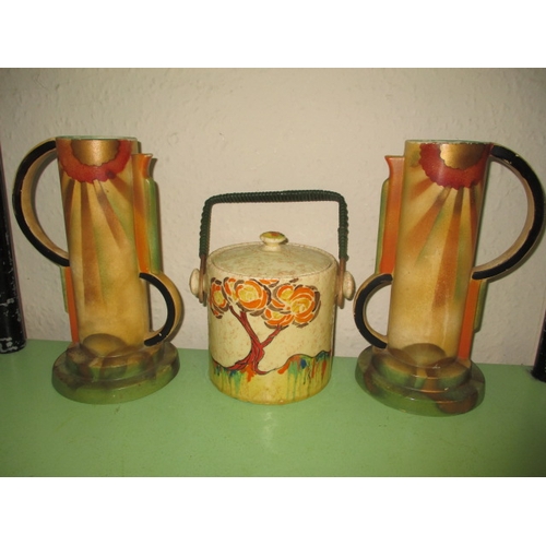 257 - A Clarice Cliff Patina tree biscuit barrel and 2 other art deco vases, retaining original raffia han... 