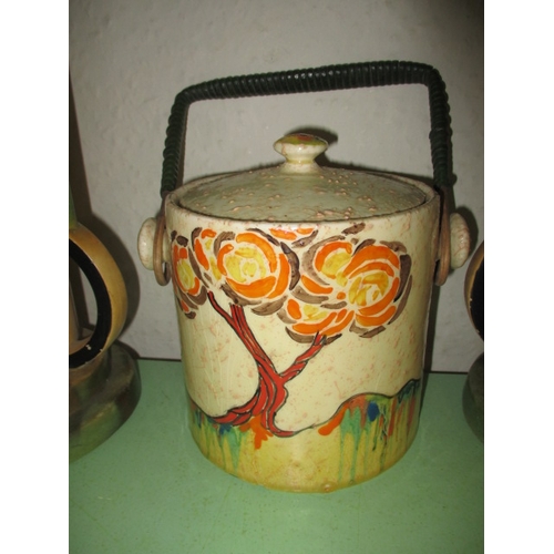 257 - A Clarice Cliff Patina tree biscuit barrel and 2 other art deco vases, retaining original raffia han... 