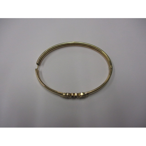 80 - A 9ct yellow gold bangle with 3 garnets, approx. weight 8.4g, in useable pre-owned condition with on... 