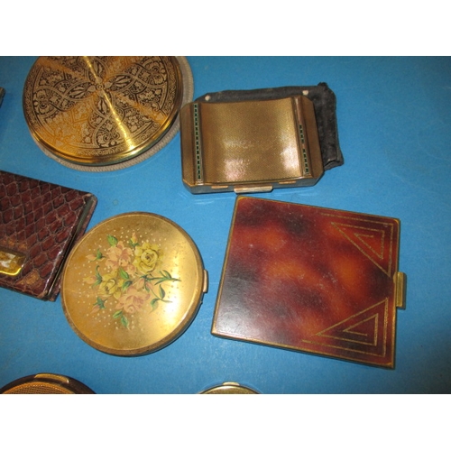 262 - A large collection of vintage powder compacts, to include examples by Coty and Stratton, all with us... 