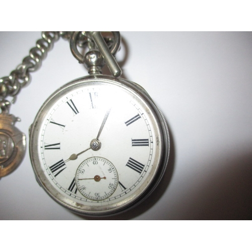 128 - An antique silver pocket watch with albert chain, in current working order, general use  related mar... 