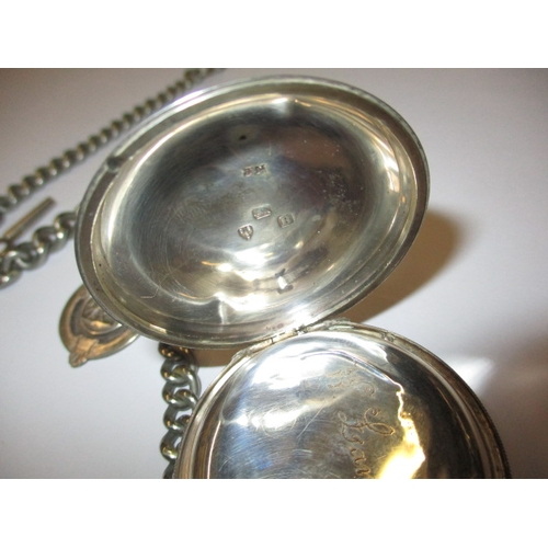 128 - An antique silver pocket watch with albert chain, in current working order, general use  related mar... 