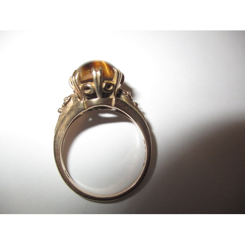 16 - A vintage 9ct gold ring with cabochon tigers eye stone, approx. ring size ‘N’, approx. weight 4.2g i... 