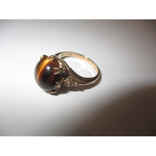 16 - A vintage 9ct gold ring with cabochon tigers eye stone, approx. ring size ‘N’, approx. weight 4.2g i... 