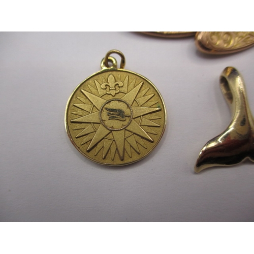 87 - Two Tiffany and Co 585 gold cruise ship medallions, a gold whale tail pendant marked 14k and a 9ct g... 