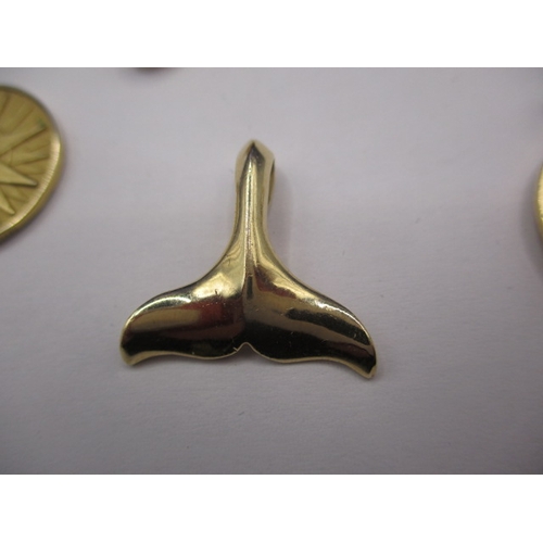 87 - Two Tiffany and Co 585 gold cruise ship medallions, a gold whale tail pendant marked 14k and a 9ct g... 