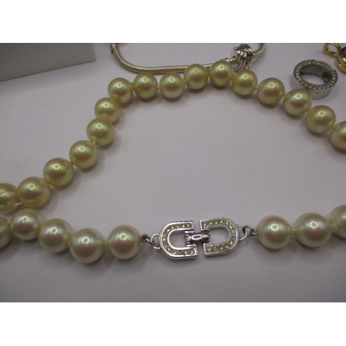 164 - A genuine Pandora bracelet and a Christian Dior necklace, both in good pre-owned condition