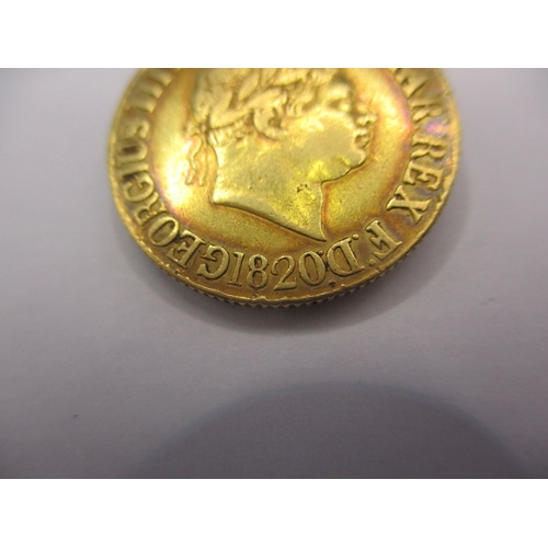 180 - A George III gold sovereign dated 1820, a circulated coin with fine definition of features