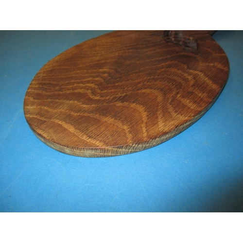 259 - A vintage Robert Thompson (Mouseman) cheese board, having a well carved mouse, general use related m... 