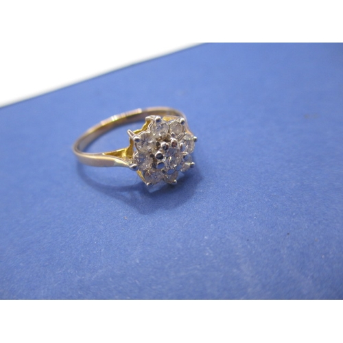 23 - An 18ct gold diamond daisy ring. Approx. ring size L, approx. weight 2.1g