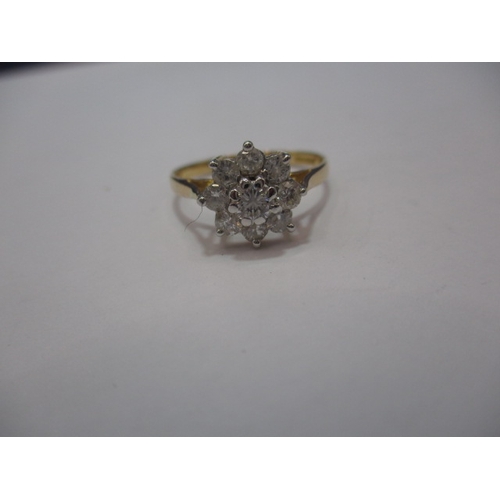 23 - An 18ct gold diamond daisy ring. Approx. ring size L, approx. weight 2.1g