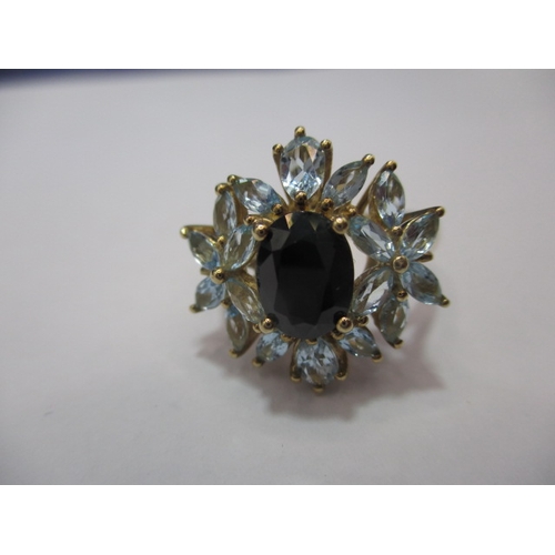 24 - A 9ct gold dress ring set with aquamarine and a central sapphire. Approx. ring size Q. Approx. weigh... 