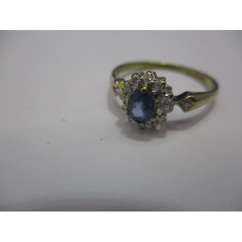 28 - A 9ct gold ring, with central Cylon sapphire, surrounded by diamonds and diamond set shoulders. Appr... 