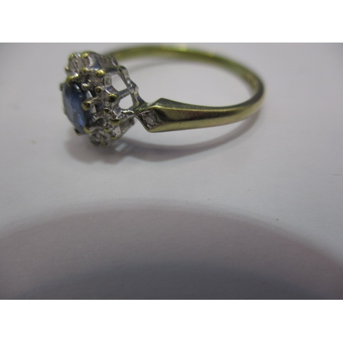 28 - A 9ct gold ring, with central Cylon sapphire, surrounded by diamonds and diamond set shoulders. Appr... 