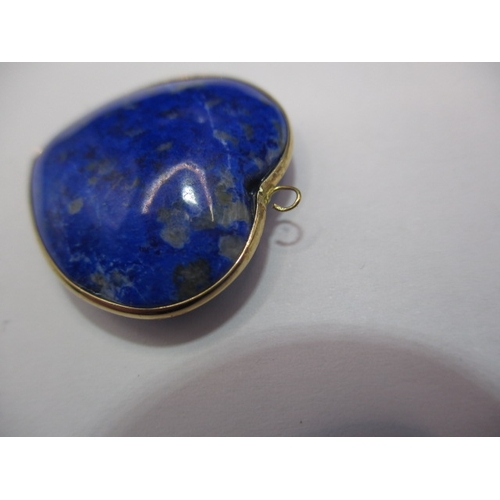 120 - An antique lapis lazuli heart shaped pendant, with yellow metal mount, worn top eye.