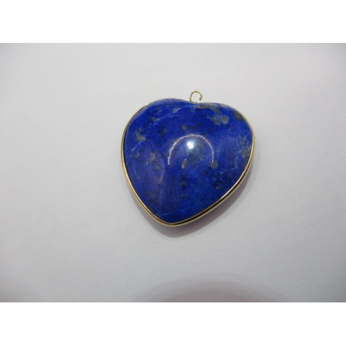 120 - An antique lapis lazuli heart shaped pendant, with yellow metal mount, worn top eye.