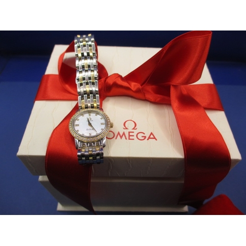 129 - A ladies Omega 1456 wrist watch, having diamond set bezel, in working order with box and all paperwo... 