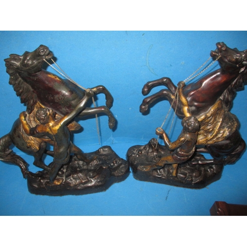 279 - A pair of cast metal Marley horses and a pair of cherubs, in useable pre-owned condition with age-re... 