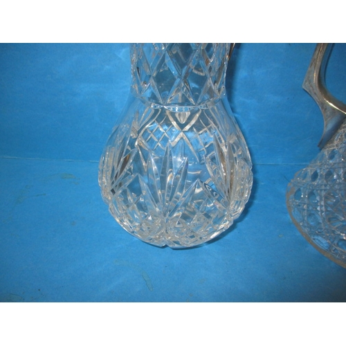 7 - A lead crystal claret jug and water jug, both with plated mounts and in good pre-owned condition, on... 