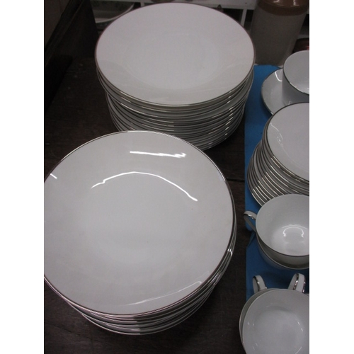 27 - A German white porcelain dinner service 10+ place settings, all looks to be in used condition with n... 