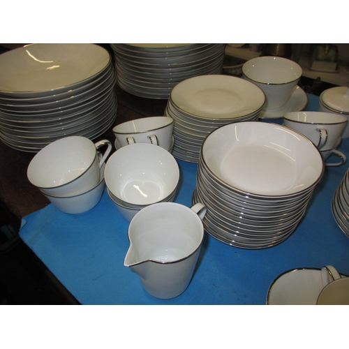 27 - A German white porcelain dinner service 10+ place settings, all looks to be in used condition with n... 