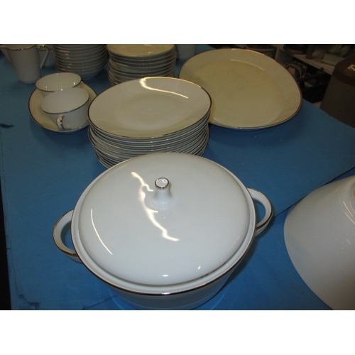 27 - A German white porcelain dinner service 10+ place settings, all looks to be in used condition with n... 