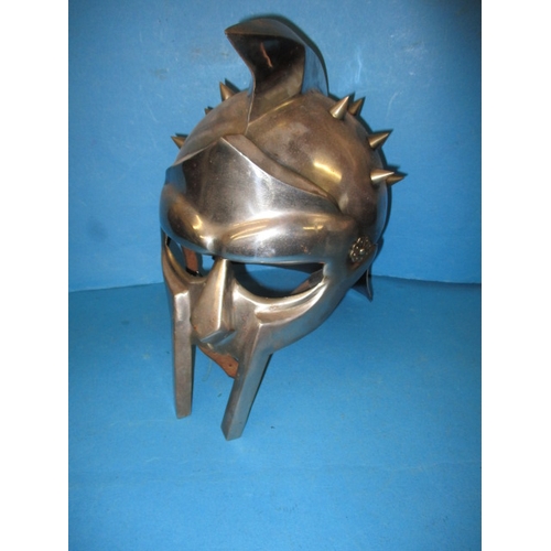 30 - A metal full size replica gladiators helmet, with leather chin strap, in useable pre-owned condition