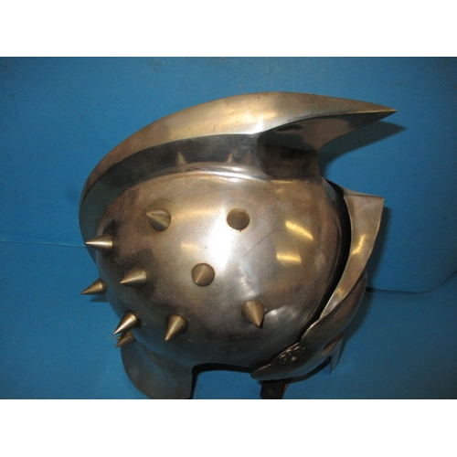 30 - A metal full size replica gladiators helmet, with leather chin strap, in useable pre-owned condition