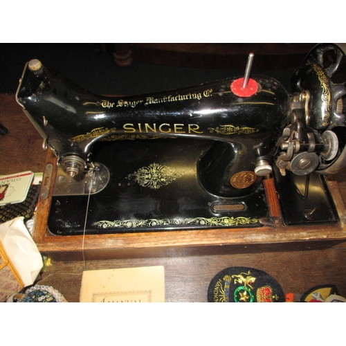 38 - A vintage hand cranked Singer sewing machine and mid-century work box with contents, all in used con... 