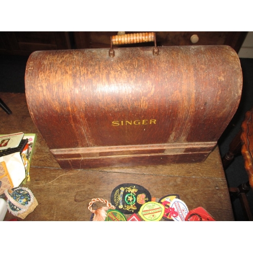 38 - A vintage hand cranked Singer sewing machine and mid-century work box with contents, all in used con... 