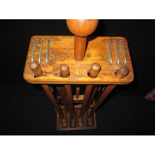 41 - A garden croquet set on wheeled wood stand, in used condition and a set of boules