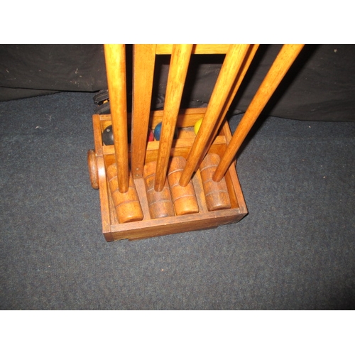 41 - A garden croquet set on wheeled wood stand, in used condition and a set of boules