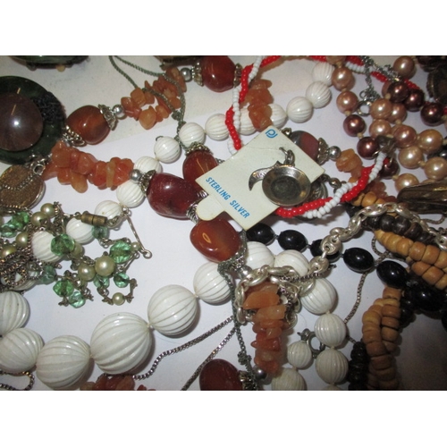 44 - A parcel of costume jewellery, to include a silver necklace pendant, all in used condition