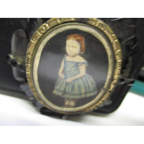 50 - An antique brooch with hand painted central panel of a child, possibly a mourning brooch, some damag... 