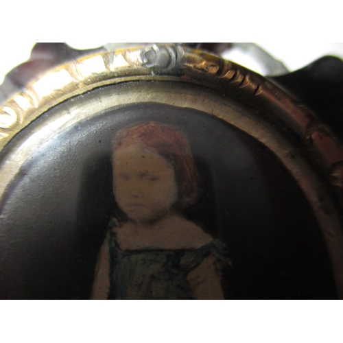 50 - An antique brooch with hand painted central panel of a child, possibly a mourning brooch, some damag... 