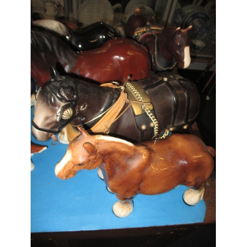 67 - A collection of ceramic horses and a Beswick dog, all in pre-owned condition with no observed damage... 