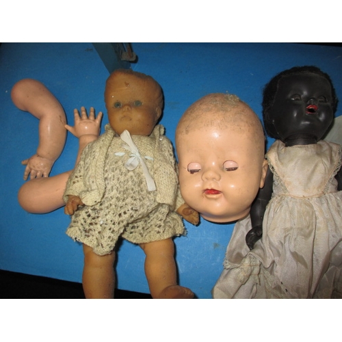 85 - A quantity of vintage dolls and a toy cot, all in well used condition some with damages