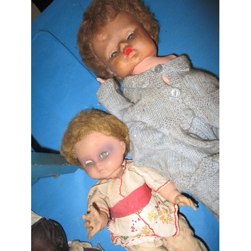 85 - A quantity of vintage dolls and a toy cot, all in well used condition some with damages