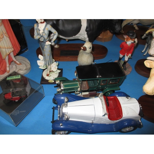 105 - A parcel of interesting collectables, to include large model cows and a Coalport art deco figurine, ... 