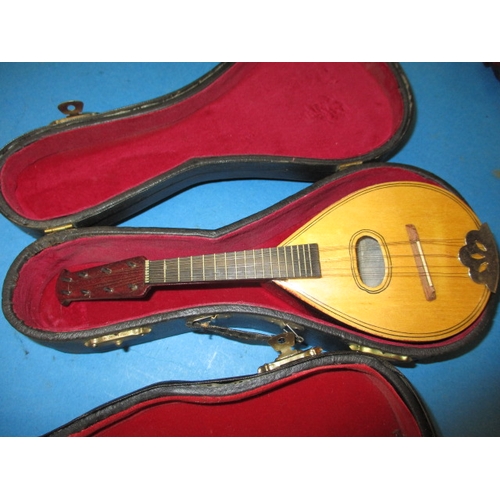 110 - A parcel of miniature string musical instruments with clockwork music movements, some in cases, appr... 