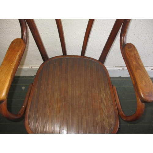 127 - A vintage Thonet bent wood arm chair, in useable pre-owned condition