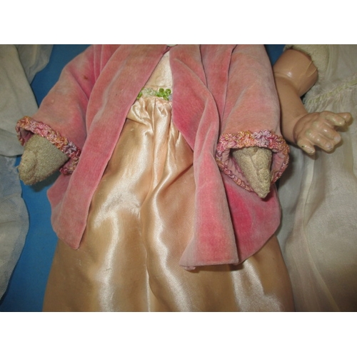 132 - Two early 20th century dolls with some period clothing, all in used condition with use-related marks