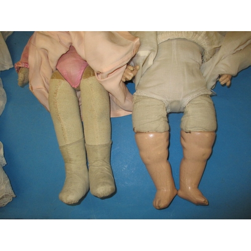 132 - Two early 20th century dolls with some period clothing, all in used condition with use-related marks