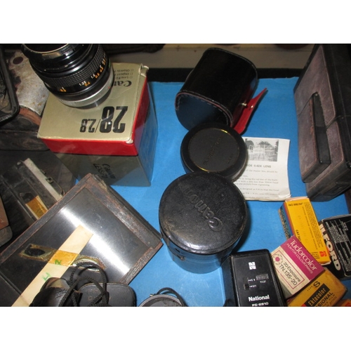 151 - A large quantity of vintage cameras and accessories, to include plate cameras and examples by Canon ... 